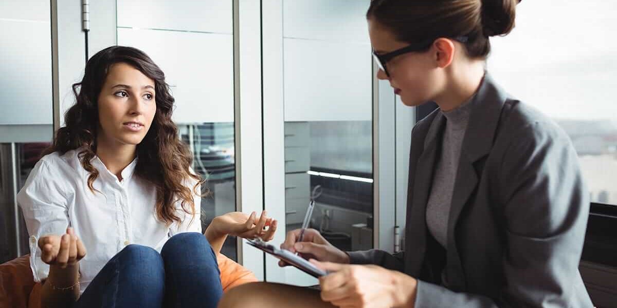 gender specific rehab woman talking to female therapist in a gender specific rehab