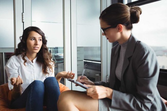 gender specific rehab woman talking to female therapist in a gender specific rehab