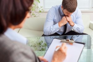 sad man in therapy an an oxycontin addiction treatment center in california