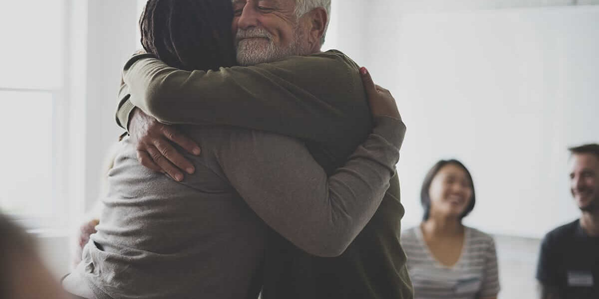 two adults hugging on self injury awareness day
