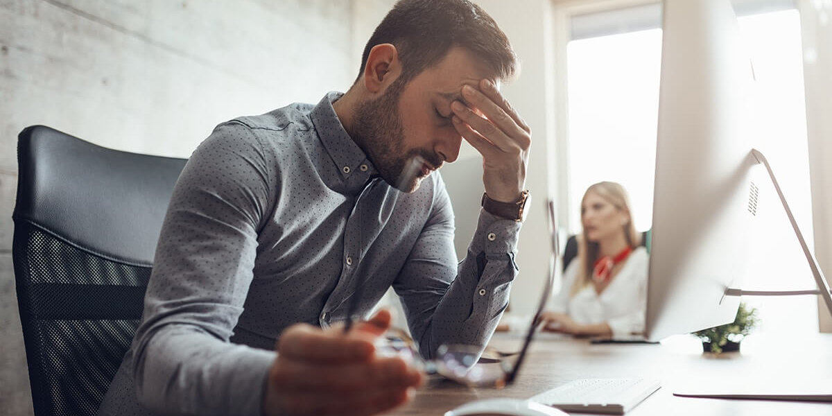 stress awareness month stressed out businessman sitting at his desk during stress awareness month