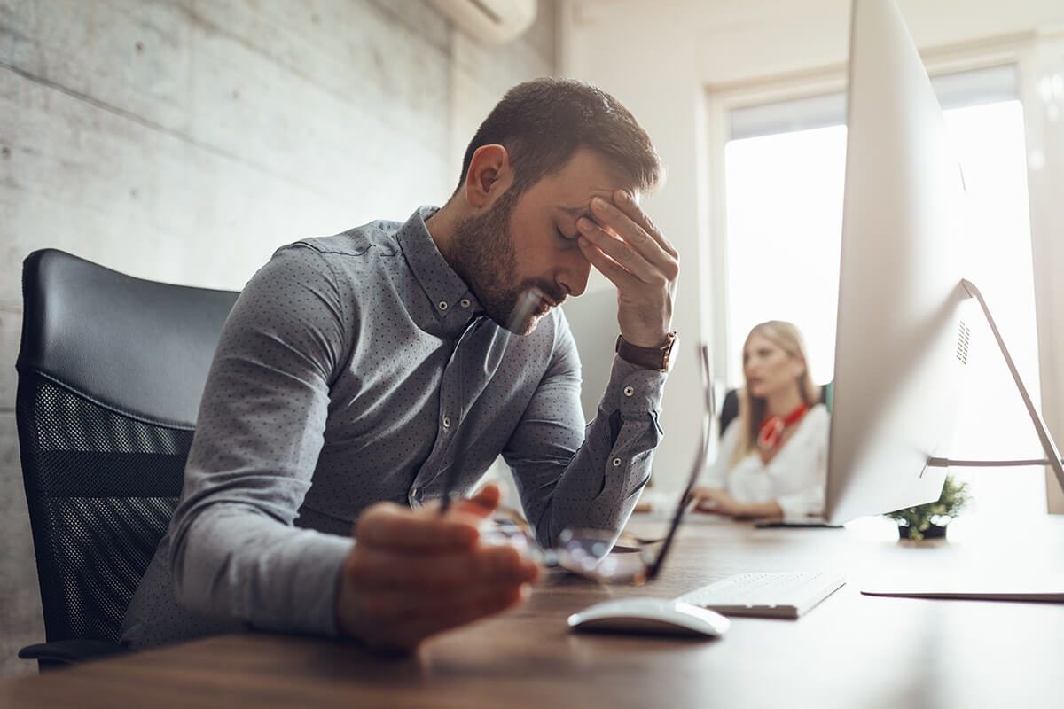 stress awareness month stressed out businessman sitting at his desk during stress awareness month