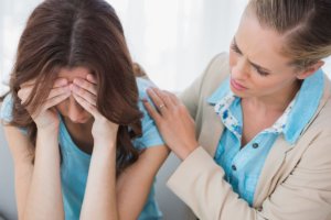 female therapist consoling a crying woman in trauma informed care