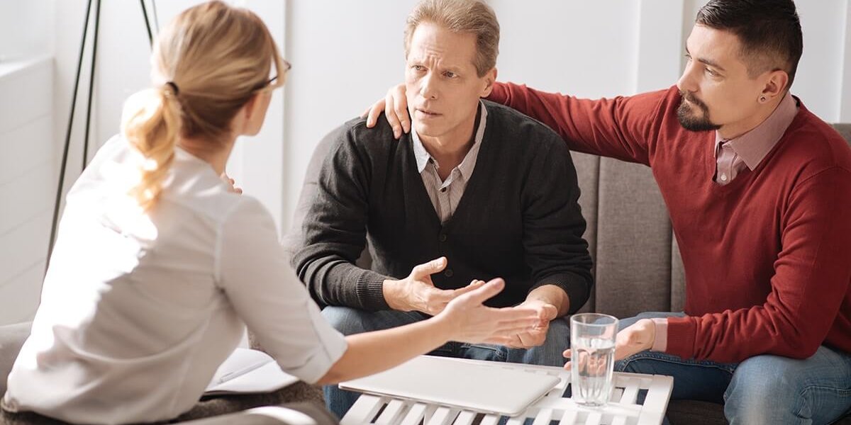 two therapists help male patient during lgbt substance abuse treatment