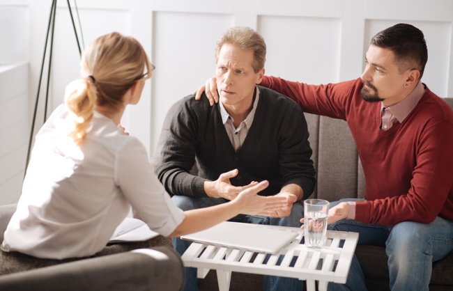 lgbt substance abuse treatment two therapists help male patient during lgbt substance abuse treatment
