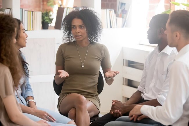 female speaks in a group as part of mental health month