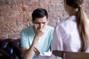 treatment professionals consults with male patient at xanax detox center