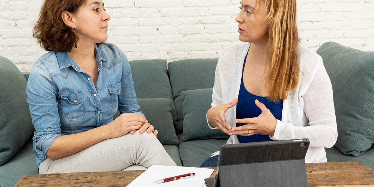 substance abuse counseling a woman sits on a couch with a woman counselor in substance abuse counseling