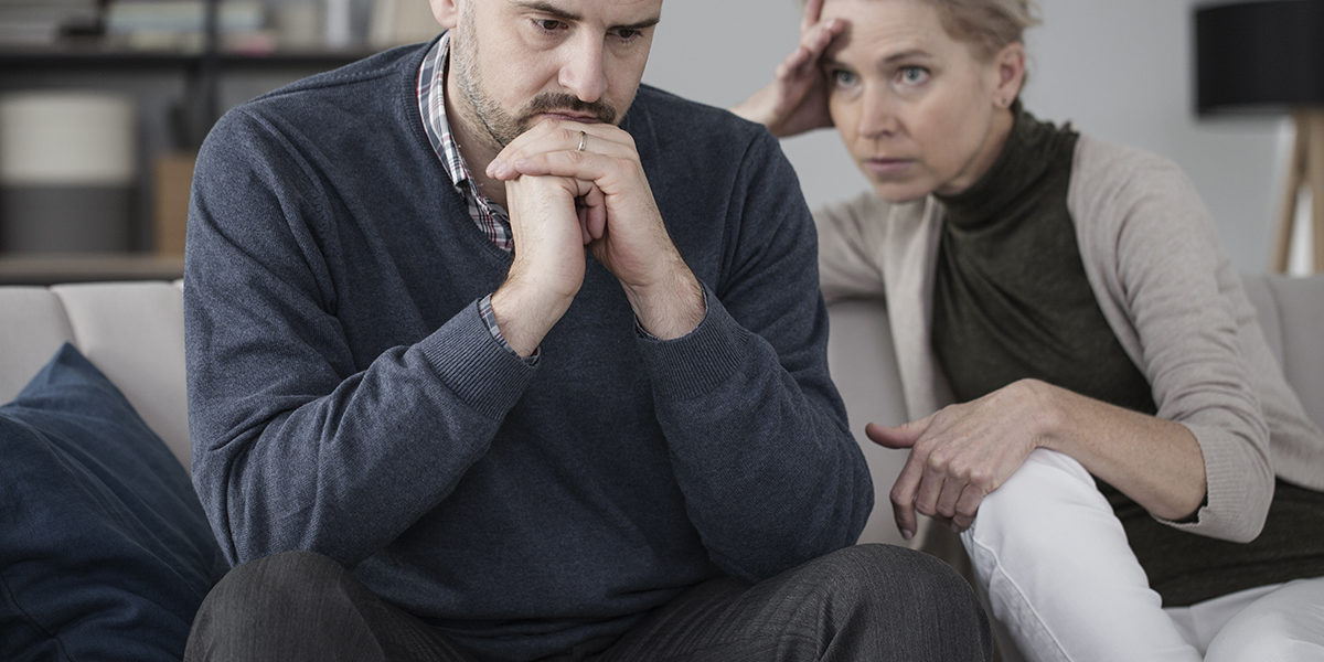 two people upset because the man cannot decide between addiction and relationships