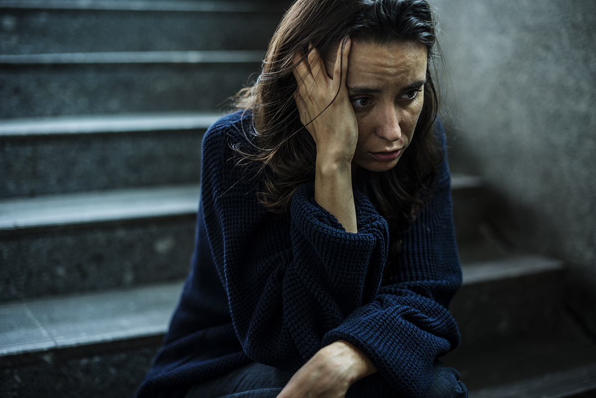 symptoms of alcohol abuse woman sits on stairs outside experiencing symptoms of alcohol abuse