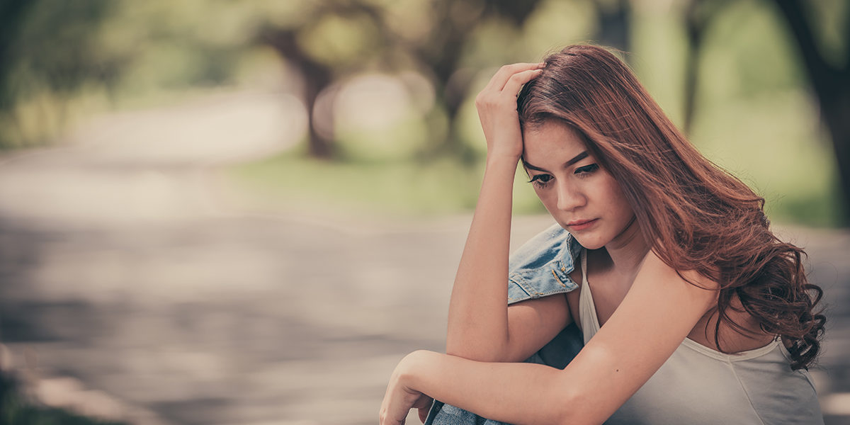 a young woman deciding between vivitrol vs suboxone