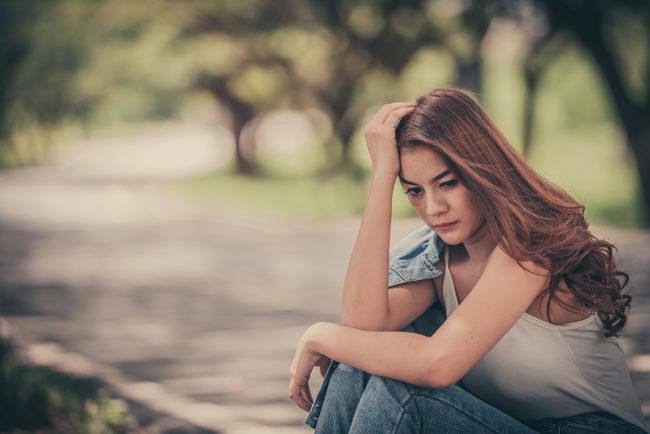 a young woman deciding between vivitrol vs suboxone