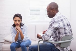 a doctor and patient going through talk therapy program